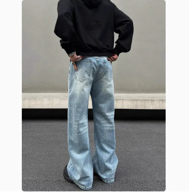 Men's blue straight leg jeans with whisker wash detail and wide leg flare