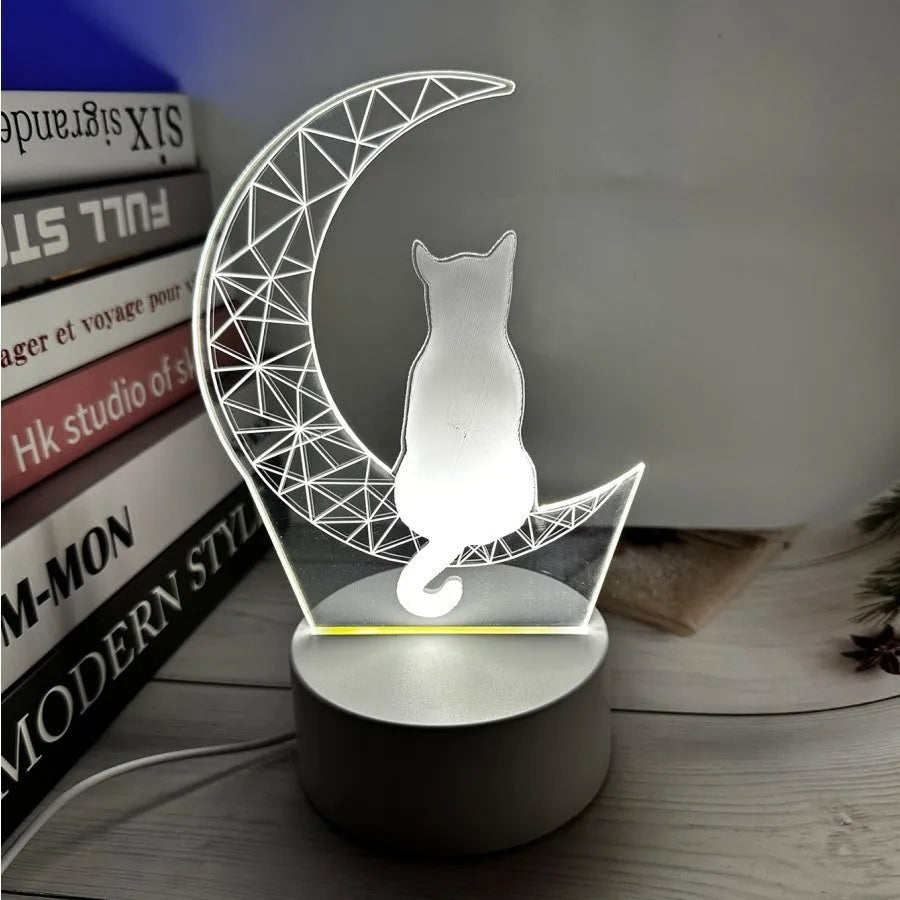 3D LED light moon and cat shape acrylic panel with remote control and USB cable on a dark surface