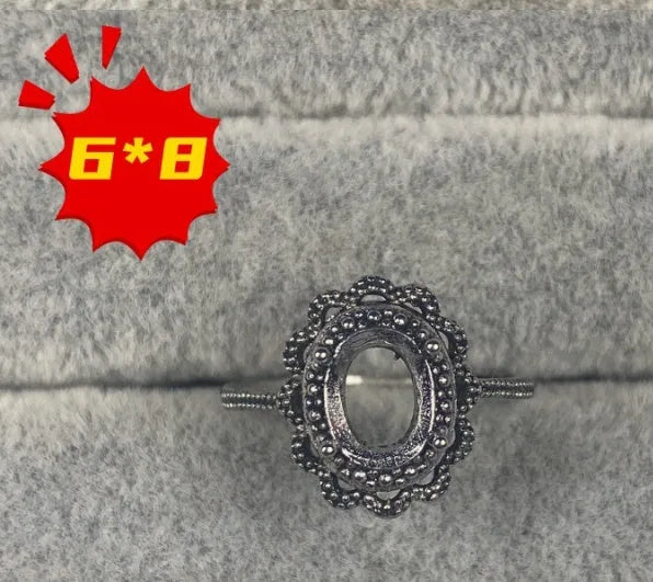 Open-mouth oval denier ring with a 6x8mm stone and five-pointed star decoration on a copper band.