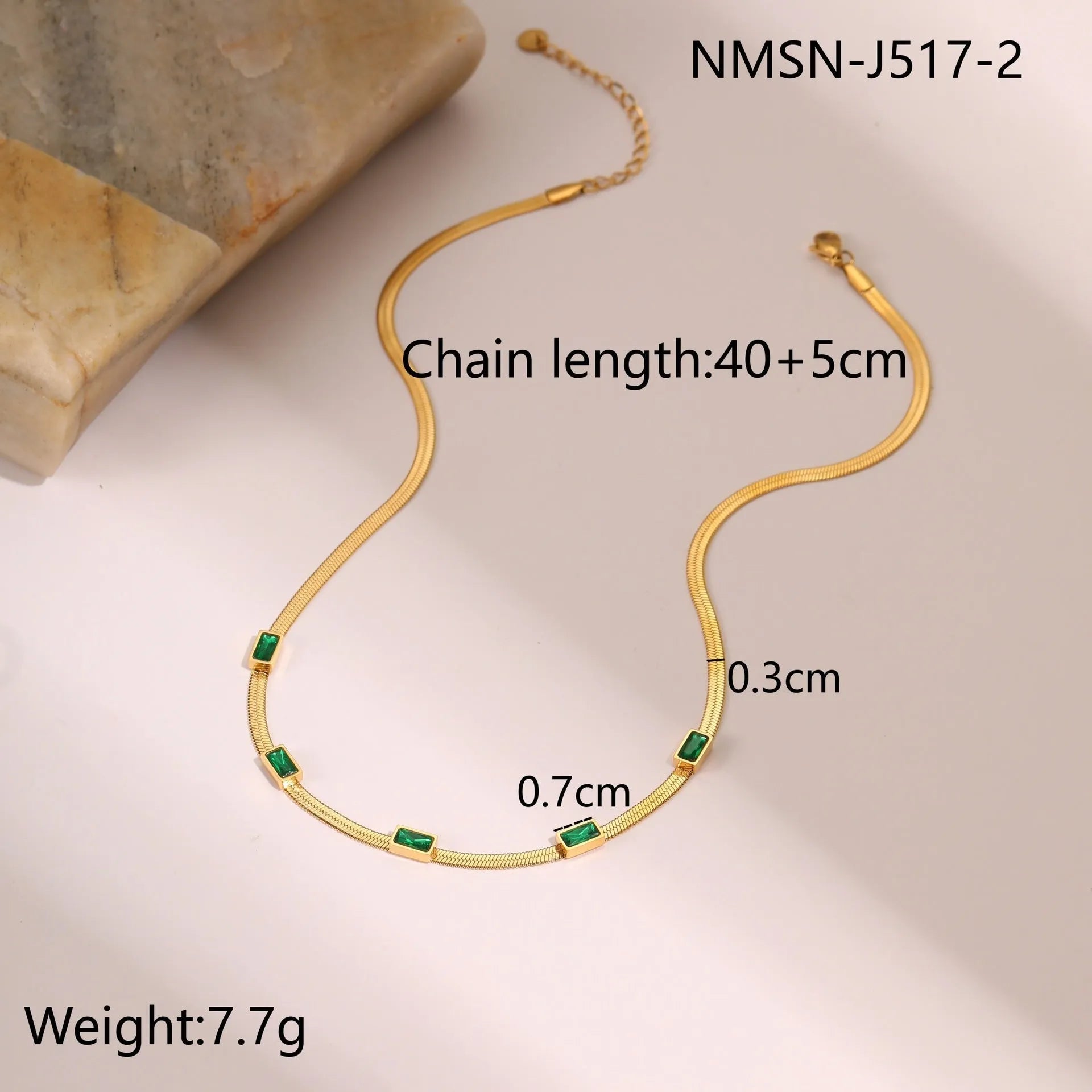 Geometric square zircon pendant on a flat stainless steel snake chain necklace in a gold colour finish.