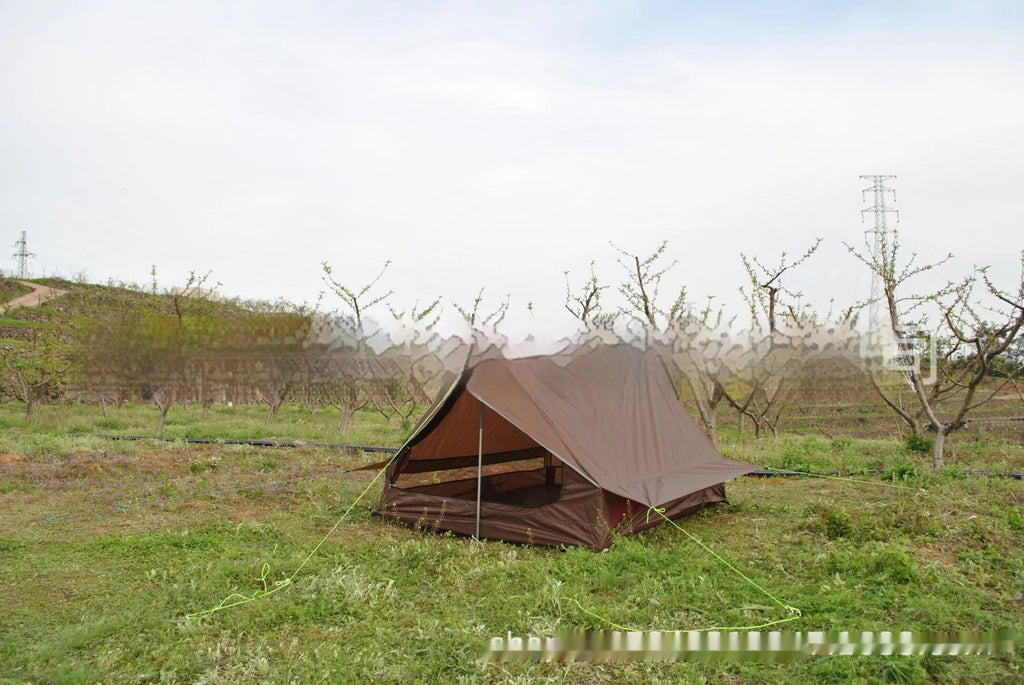 Brown or white A-line hiking tent pitched using hiking canes, showing spacious interior for 2-3 people.