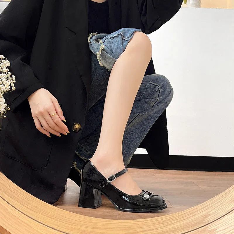 Women's apricot patent leather high heels with a round toe and chunky heel, shown with a buckle fastening.