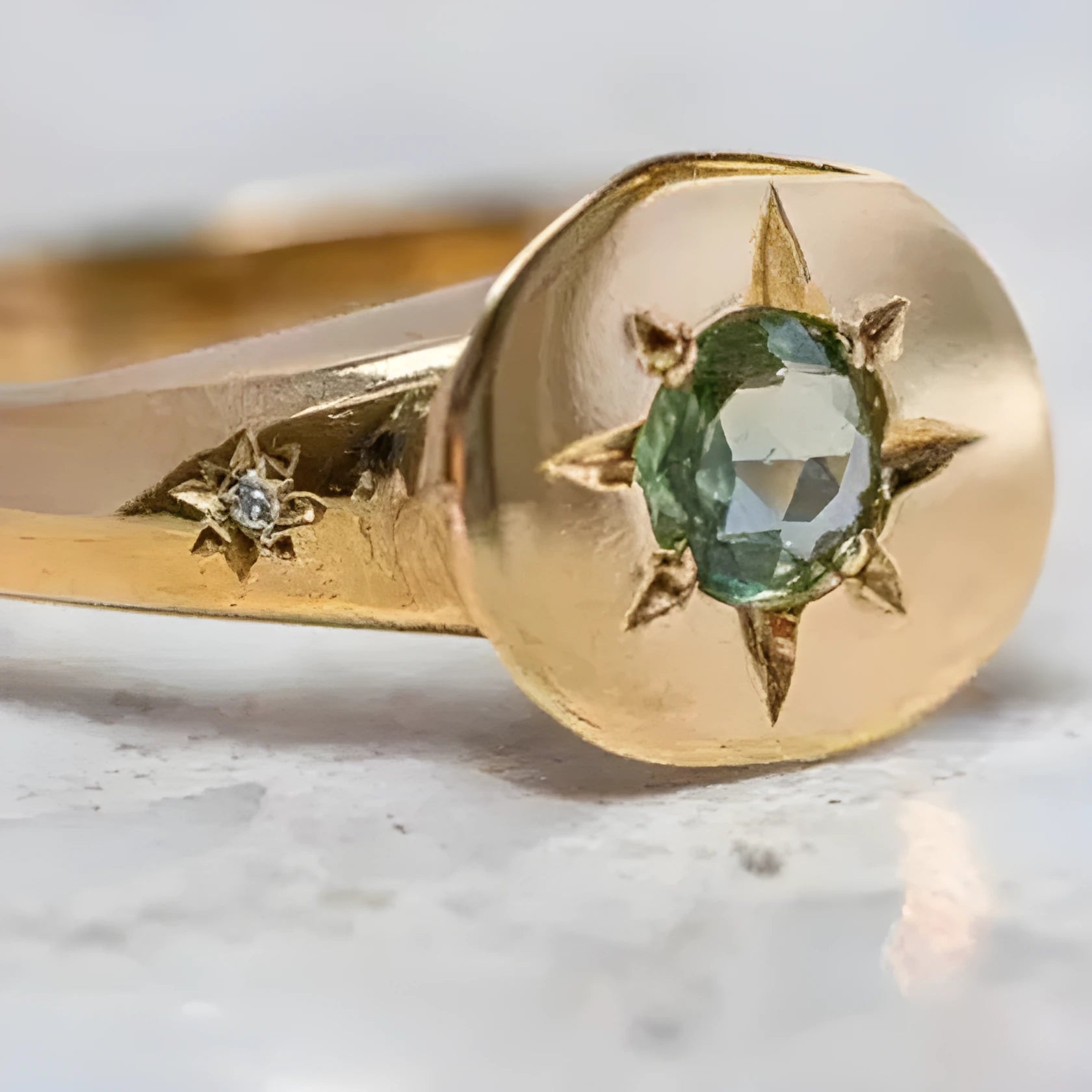 Golden adjustable ring with oval zircon centrepiece and star pattern detail