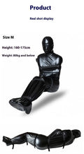Black patent leather bondage set showing full-coverage body wrap and six ratchet tie-down straps