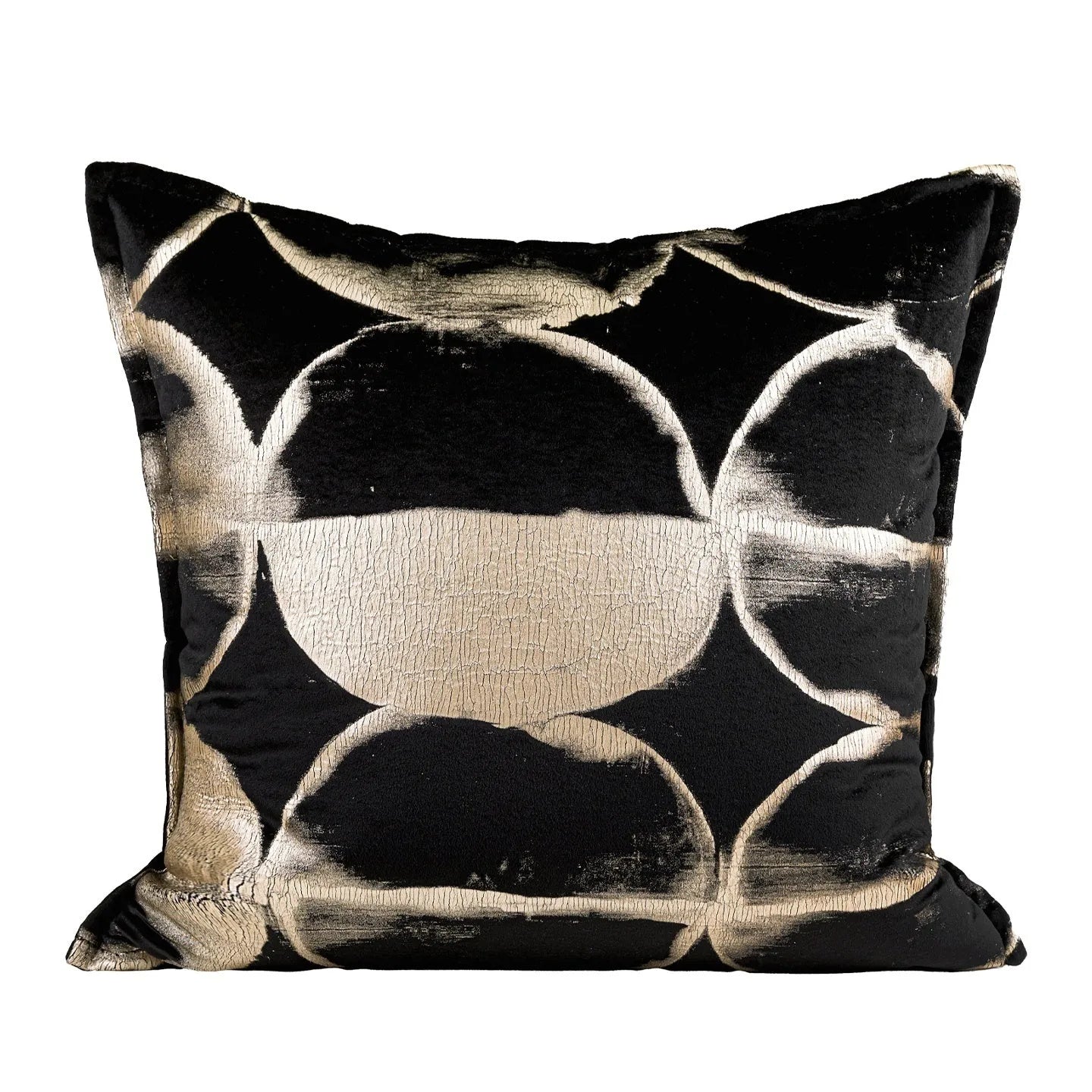Black and gold abstract pattern decorative velvet cushion on a grey sofa.