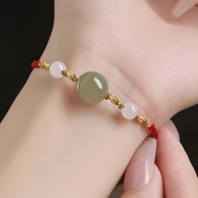 Hand-woven red rope bracelet with Hetian jade lucky beads and Chinese motif carvings