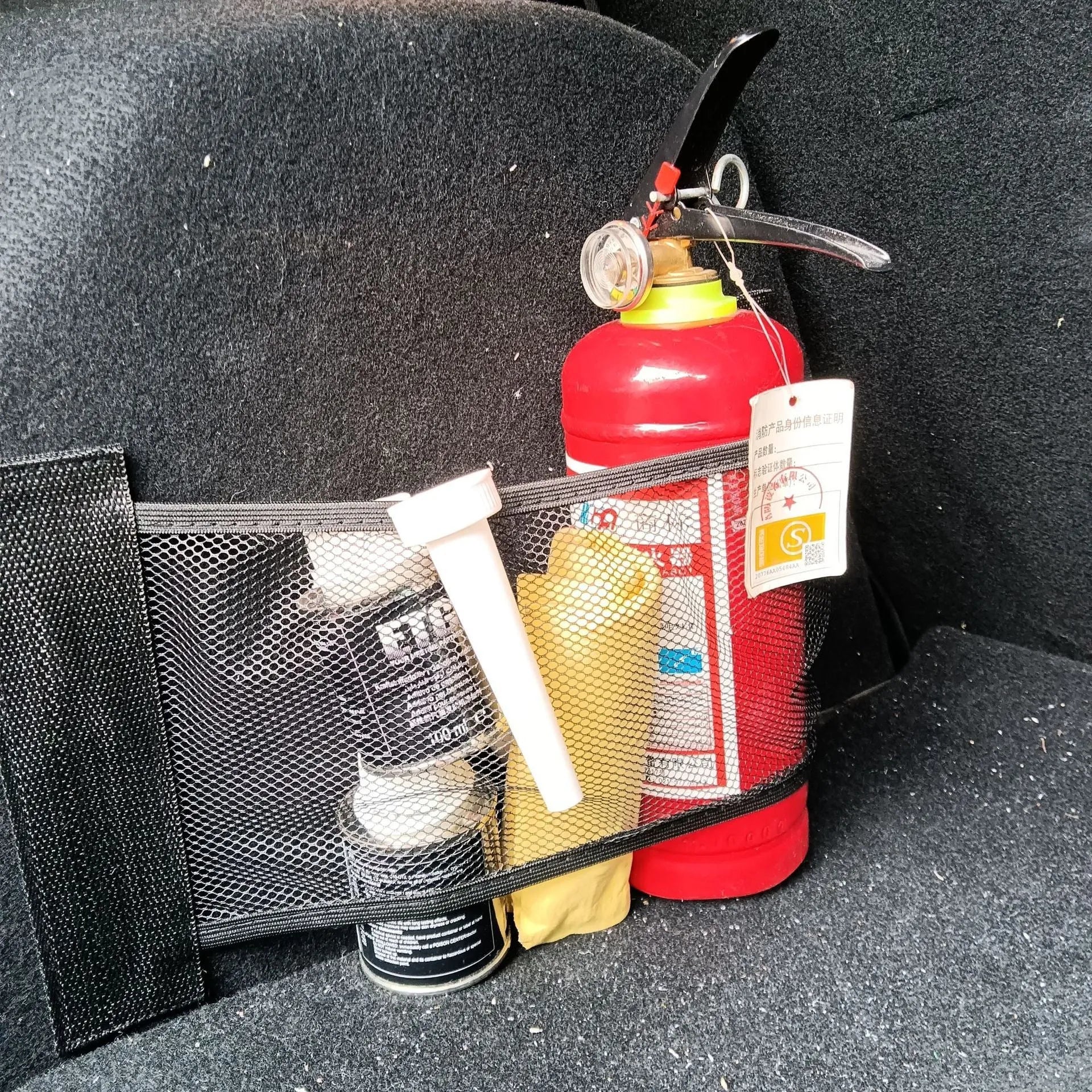 Car trunk elastic storage net in two sizes for organising loose items in vehicle boot