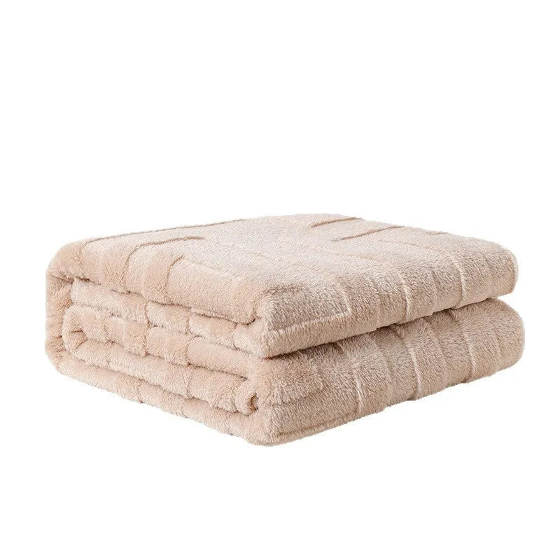 Thick square coral fleece blanket in a solid colour, draped over a sofa.