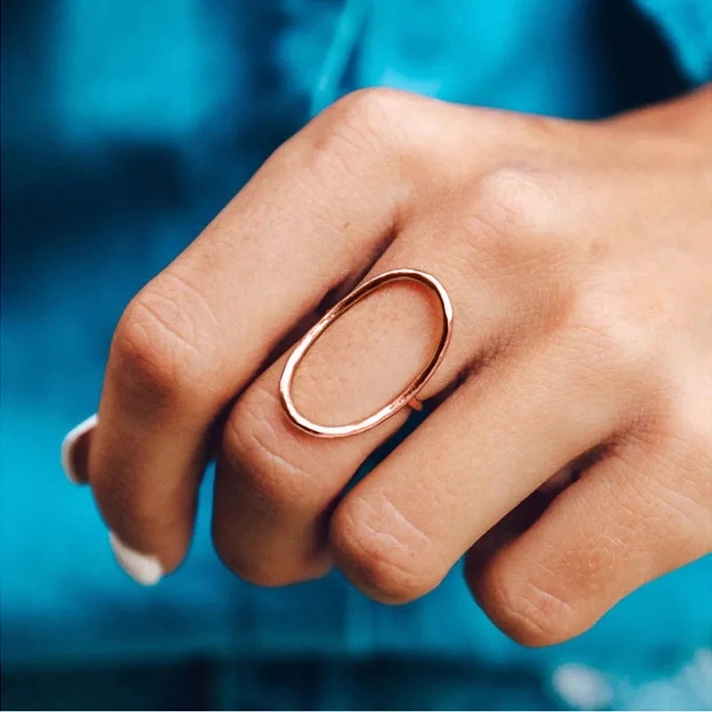 Women's geometric copper ring with zircon inlay in rose gold finish on white background