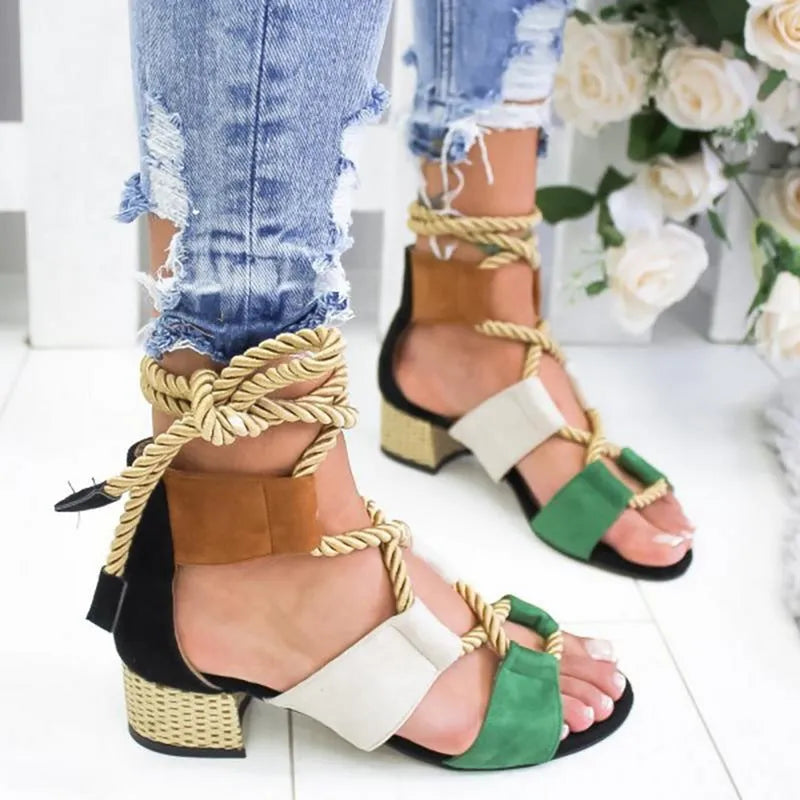 Women's beige suede sandals with thick heel, front strap, and ankle strap on a white background.