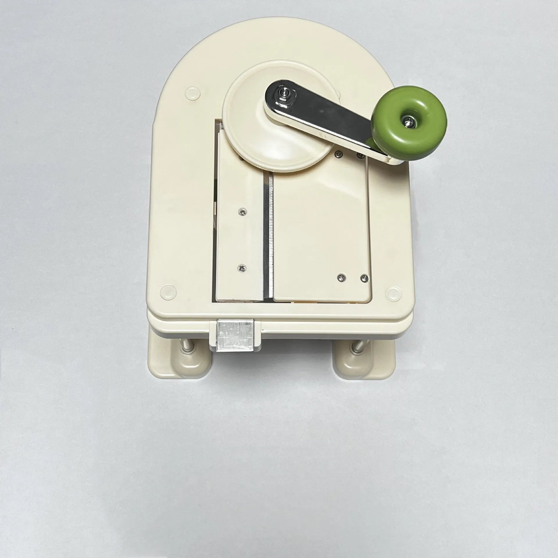 Beige kitchen vegetable slicer tool with stainless steel blades for shredding and spiralising