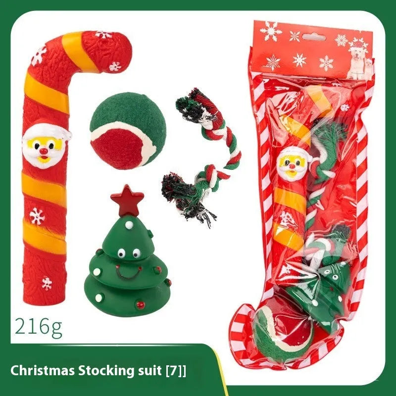 Christmas-themed vinyl dog toys including barbell, ball, rope, and Santa designs in gift packaging
