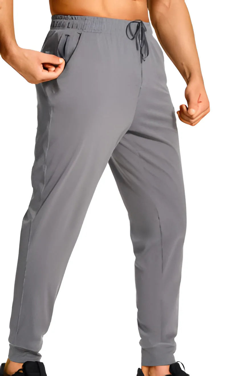 Men's loose-fit solid colour casual trousers made from polyester fabric on a hanger.
