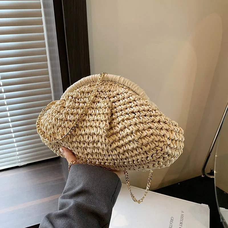 Women's khaki paper straw shoulder bag with chain strap and shell shape showing internal zippered compartment