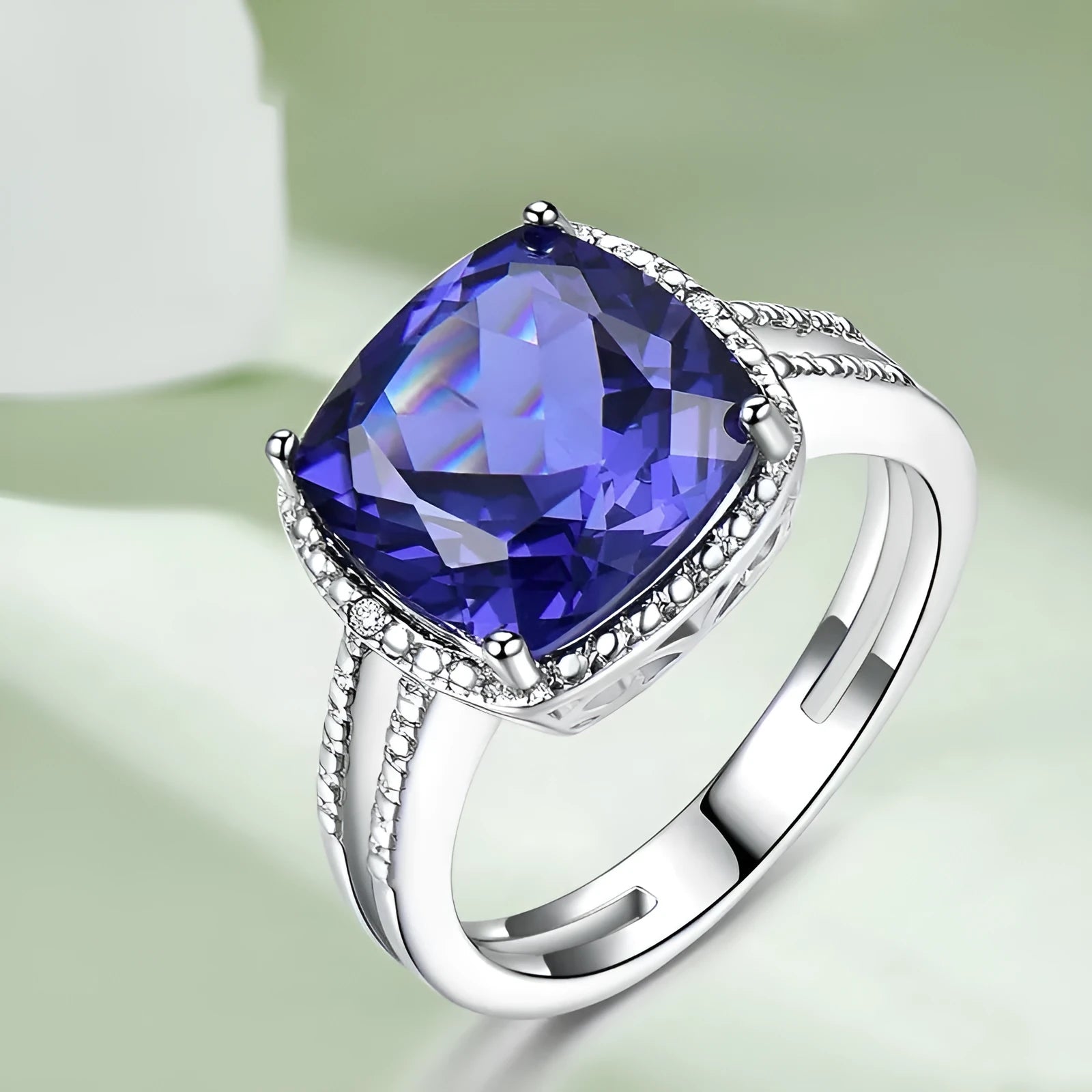 Women's sterling silver ring with blue tanzanite stone showing silver band and gemstone setting