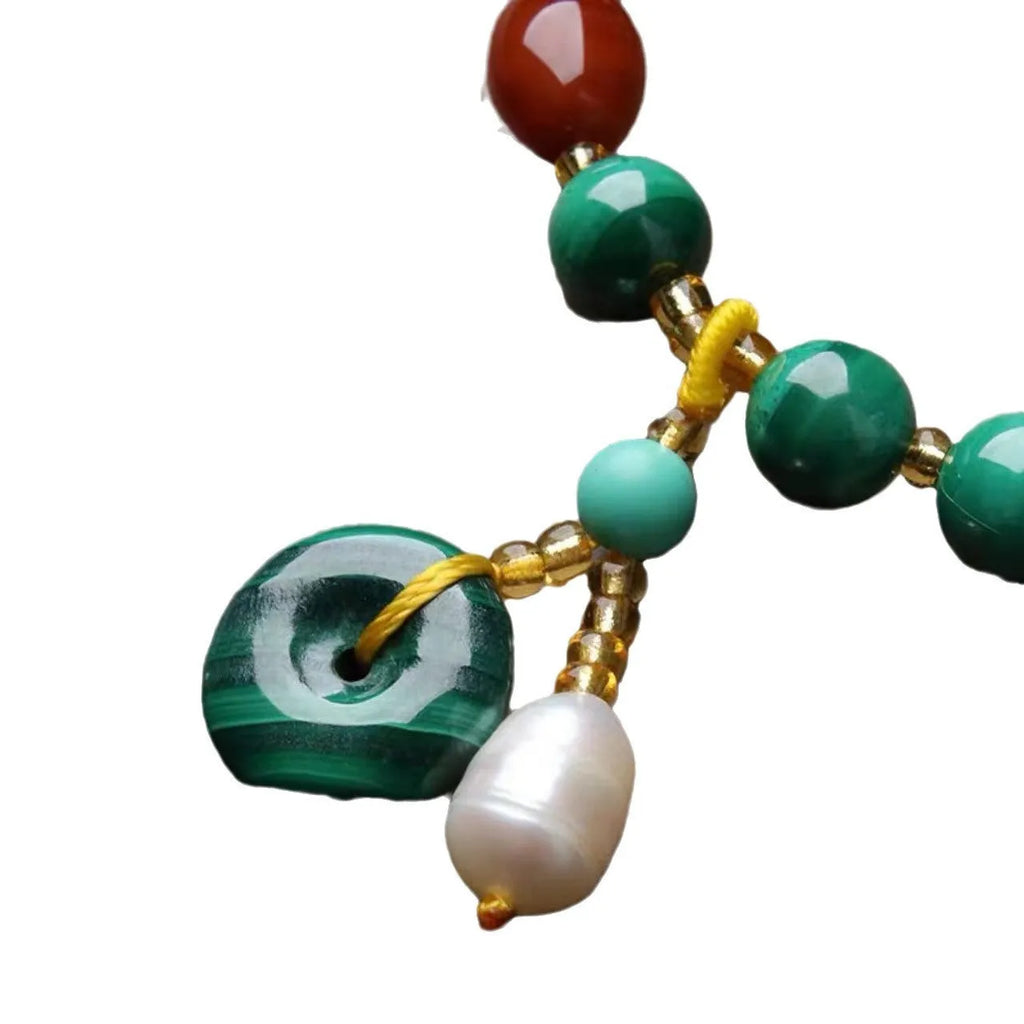 Natural malachite bracelet with southern red agate barrel beads showing green and red stone details