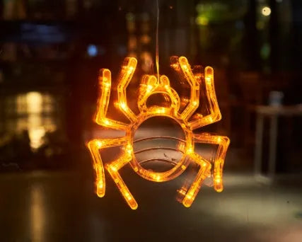 Seven Halloween LED window lights with spider, pumpkin and ghost designs on suction cups