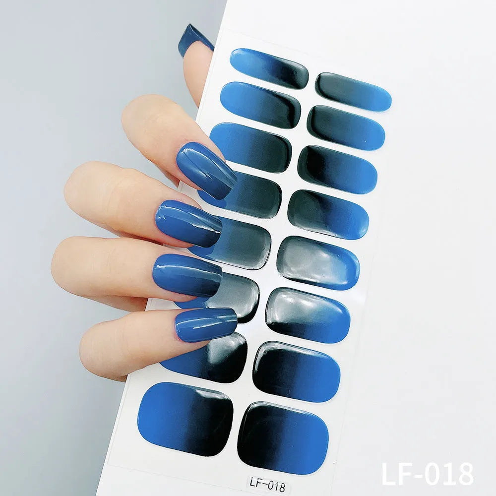 Set of 16 solid colour full nail art stickers showing patterns like cross, rose, tulip, and cartoon designs.