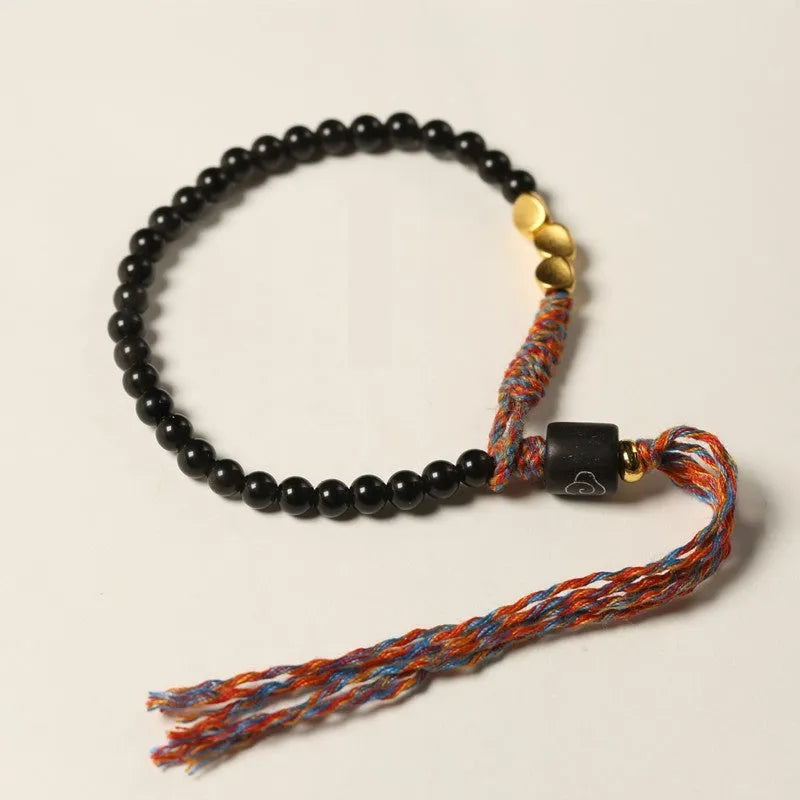 Hand-woven obsidian carrying strap bracelet showing textured surface and 4mm width