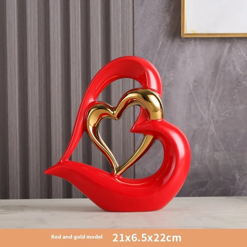 Modern white porcelain heart ornament in a metallic finish, showing its geometric shape on a table.