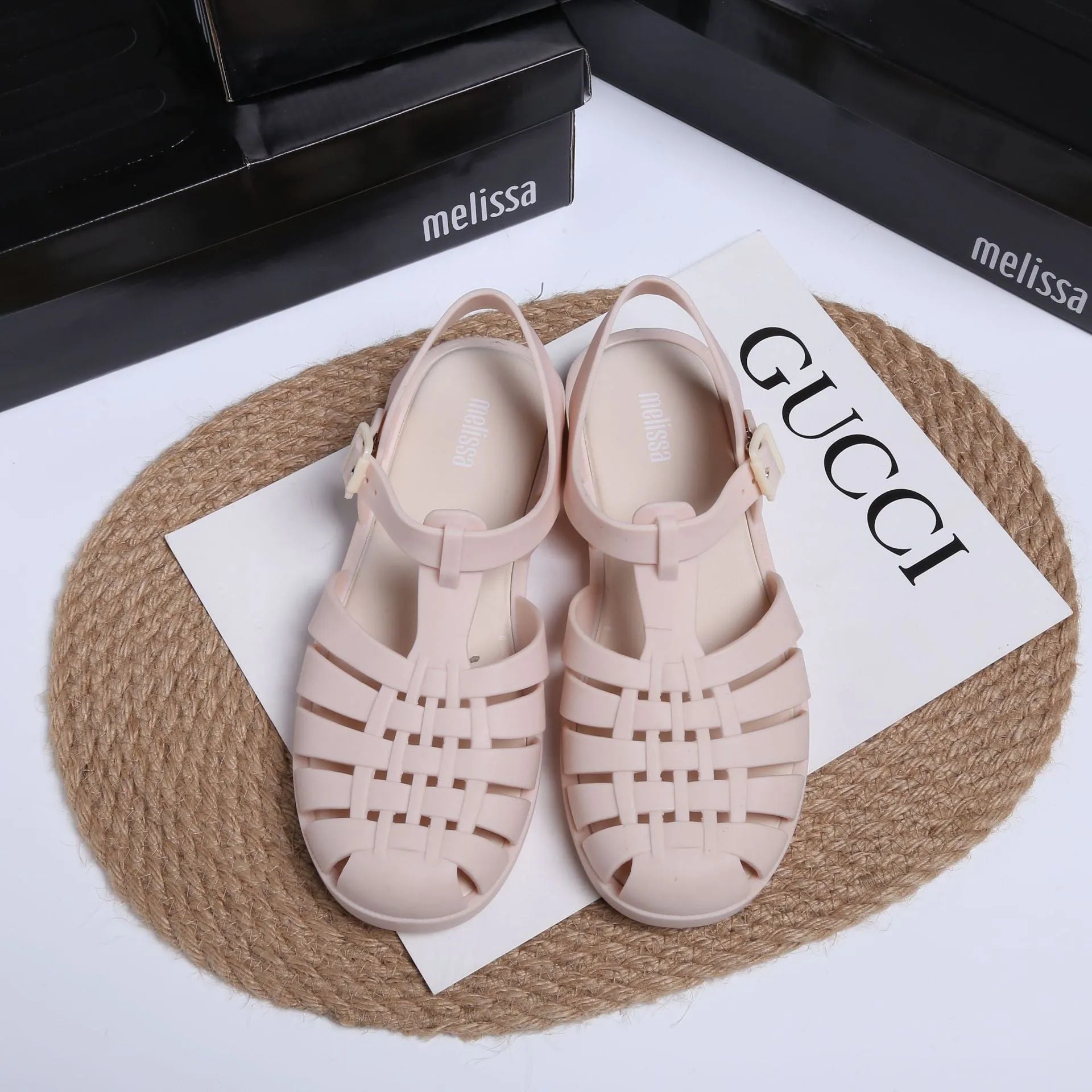 Black Roman-style sandals with buckle fastening and hollow-out design on low-top PVC upper