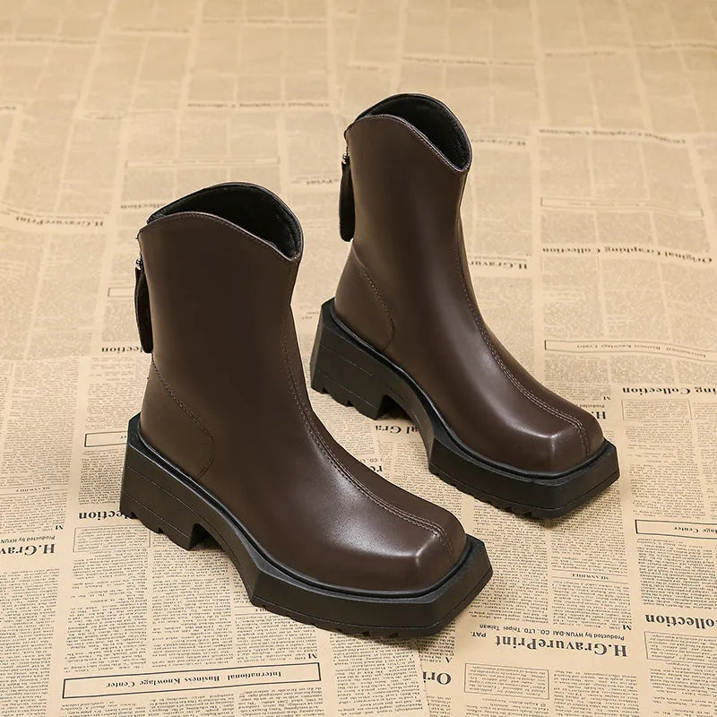 Black women's platform Martin boots with square toe and back zipper, showing mid-calf height.
