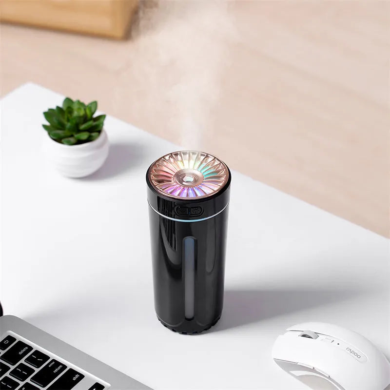 Black and white rechargeable USB humidifier with colourful lights for car and desk use.