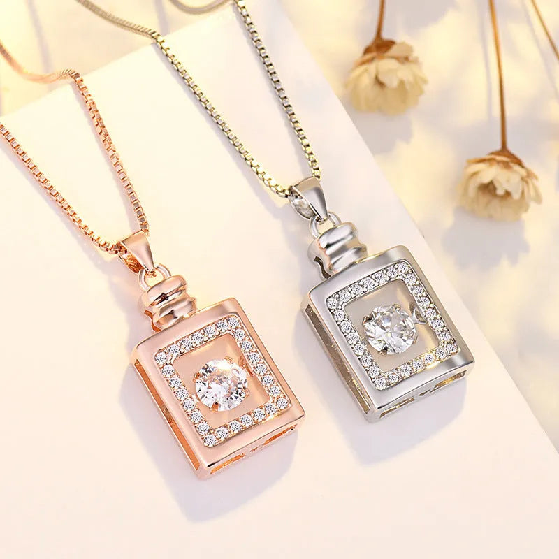 Sterling silver heart necklace with crown and bow charm detail in rose gold or silver finish
