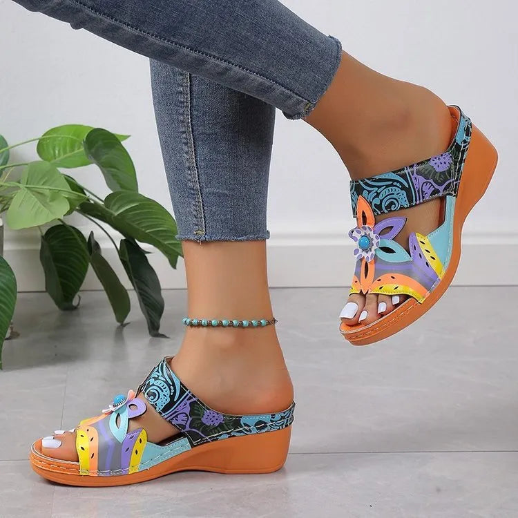 Women's ethnic patterned slippers in cowhide leather with round toe, shown in black, purple, green, and orange colours.
