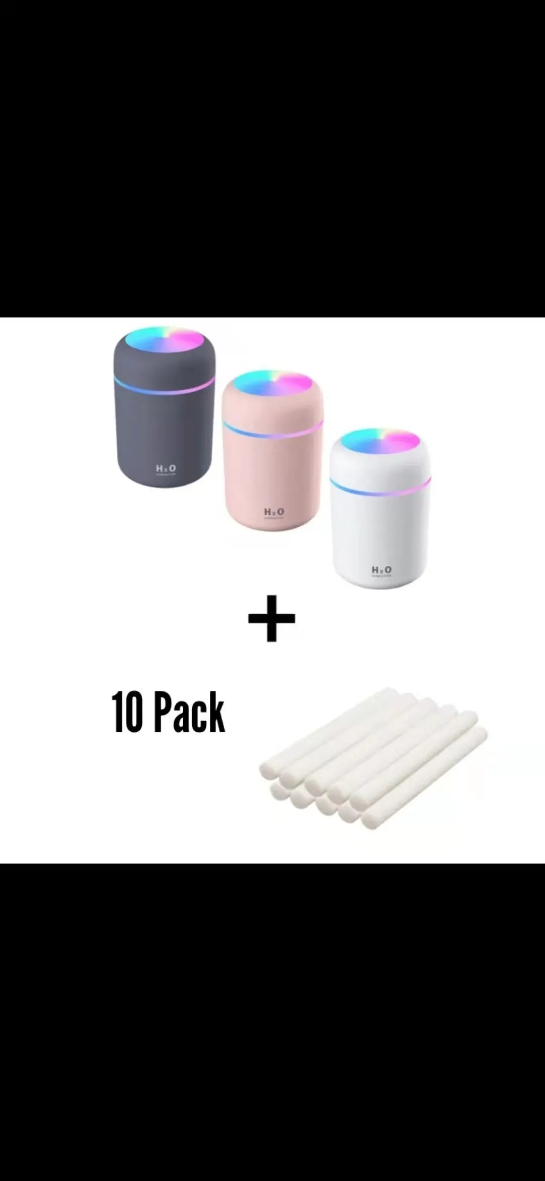 Pink USB desktop humidifier with LED lights and water tank on a wooden desk.
