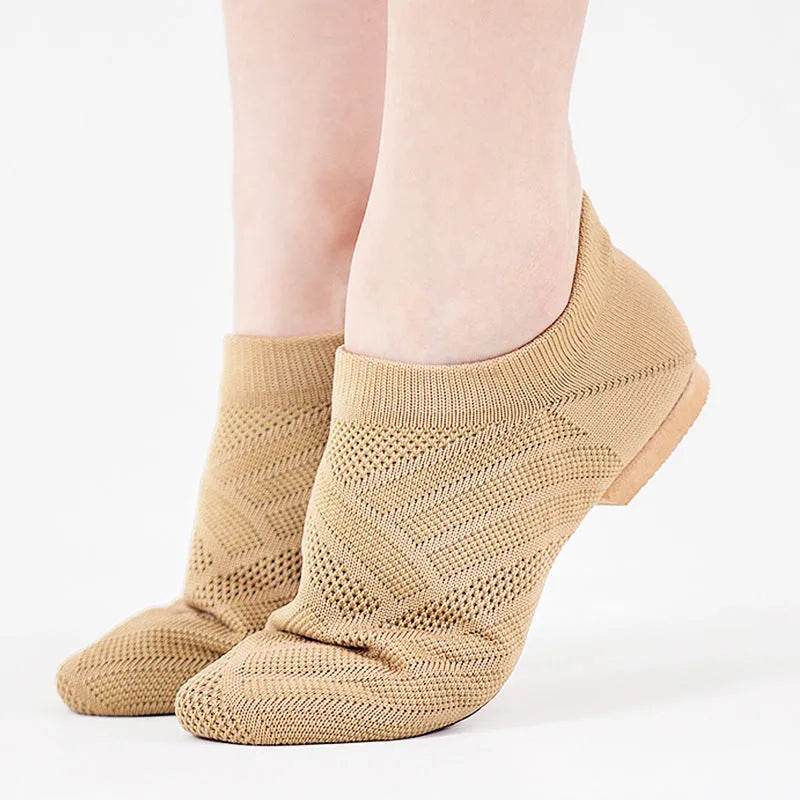 Camel coloured Latin dance shoes with cotton mesh upper and leather sole on a plain background.