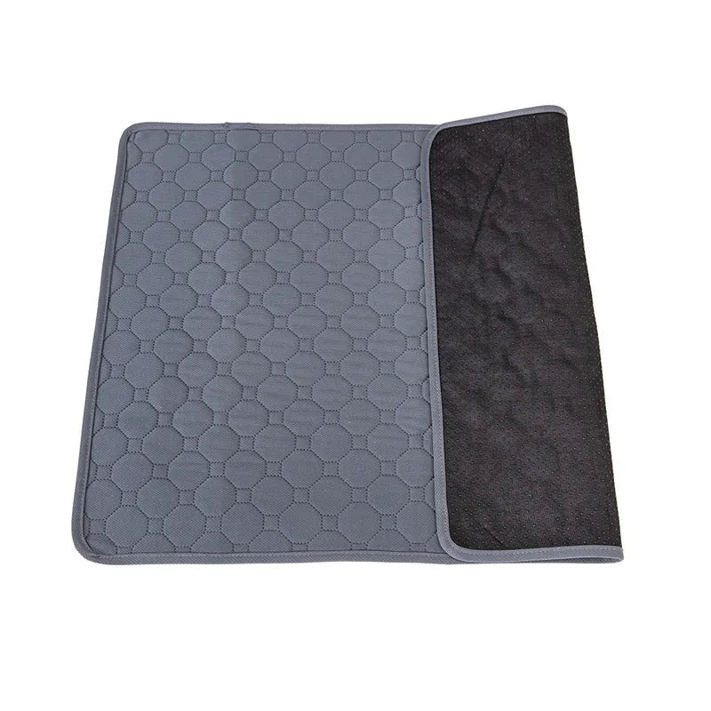 Pack of grey and tan washable, reusable dog pee pads in various sizes on a wooden floor.