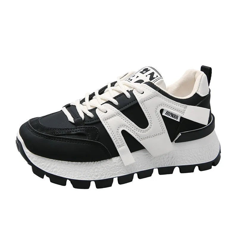 A pair of solid-colour low-top lace-up sneakers with a round toe and flat rubber sole.