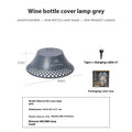 Beige wine bottle shaped camping lantern with USB-C charging port and compact dimensions