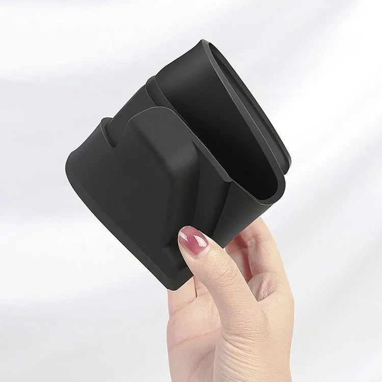 Black silicone glasses case mounted on a Tesla Model 3 or Y central armrest.