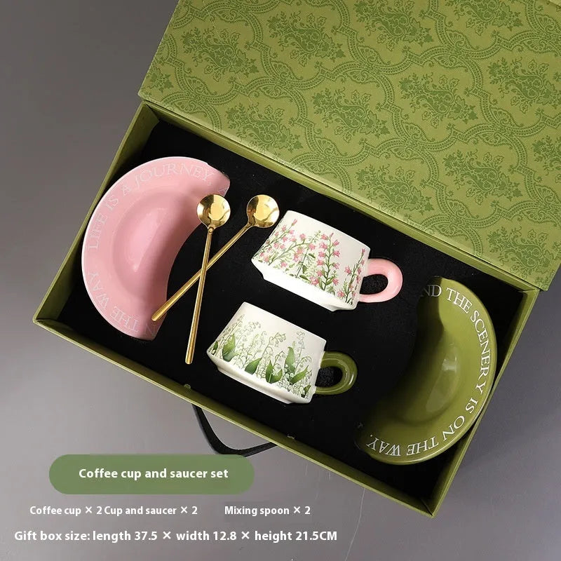 Ceramic coffee cup and saucer set for couples with stirring spoons in two design options.