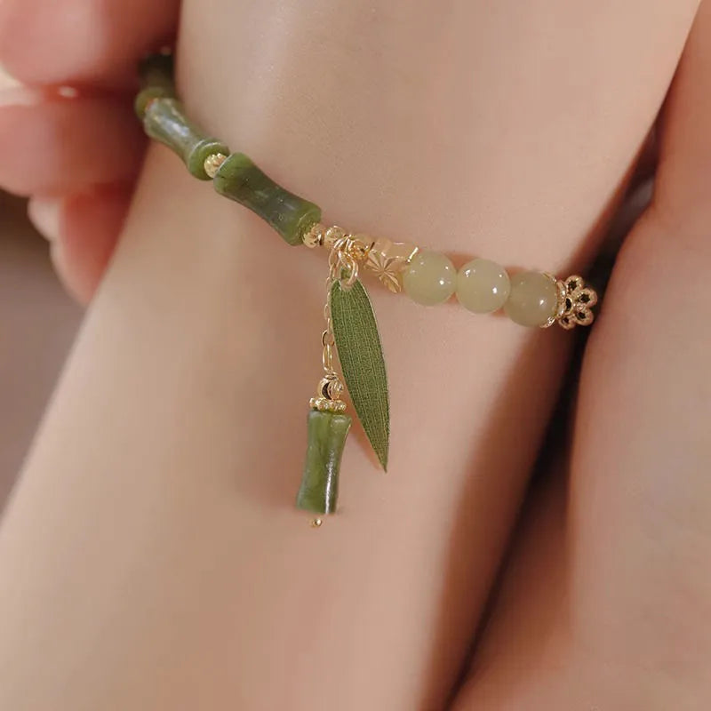 Chinese style glass bracelet with bamboo joint details in a red Lvzhu Duobao design.