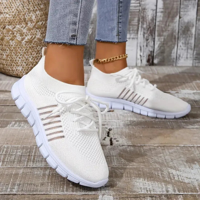 Women's casual breathable flying knit flat shoes in various colours on a white background.