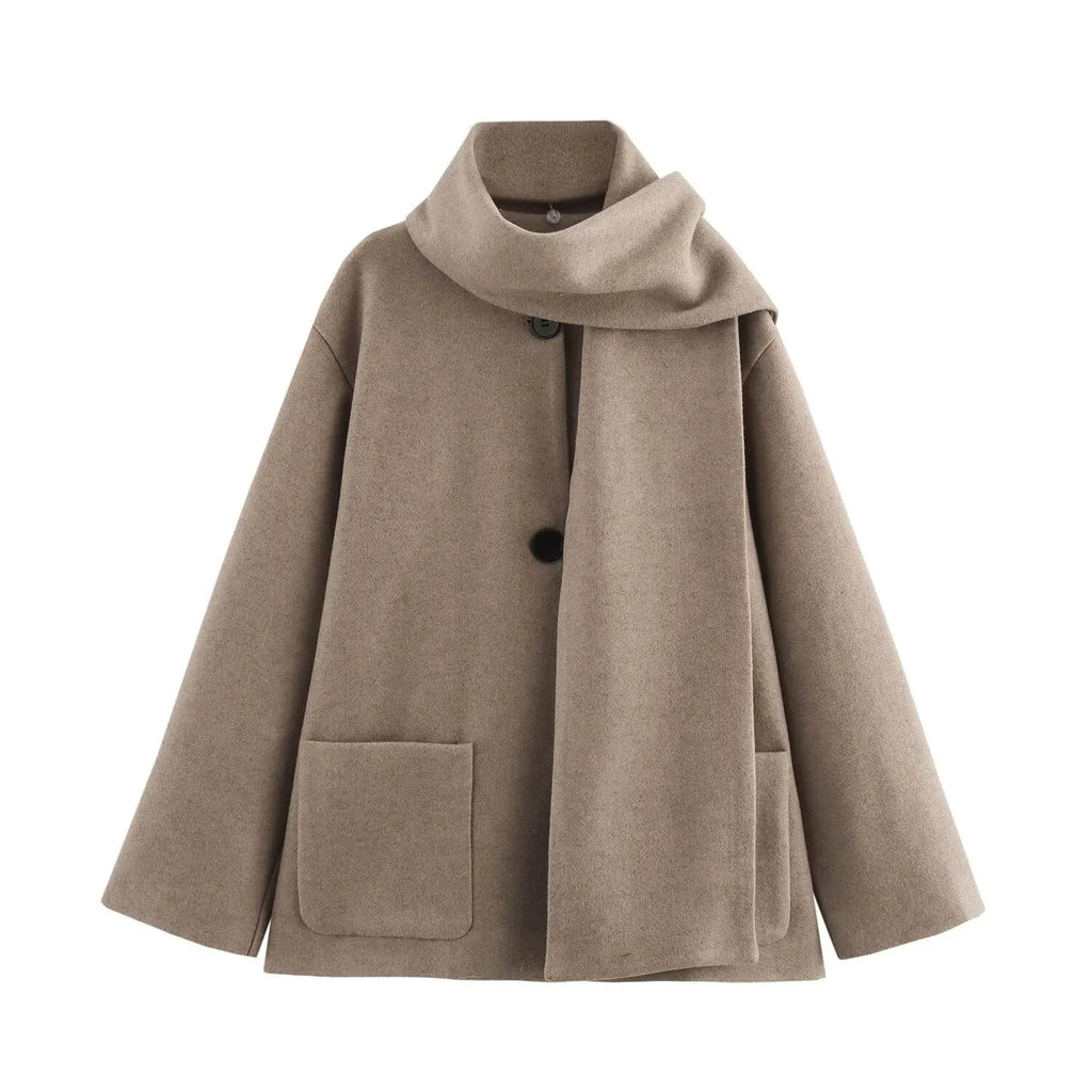Women's long beige coat with a fluffy artificial fur collar, shown on a model.
