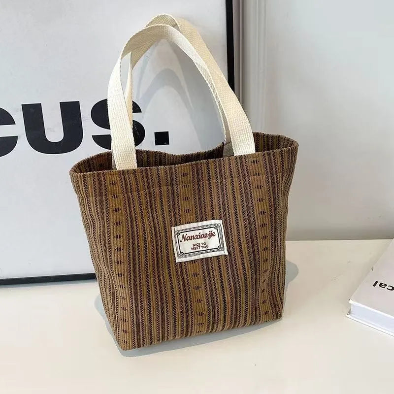 Japanese-style corduroy shoulder bag in dark brown, showing the textured fabric and adjustable strap.