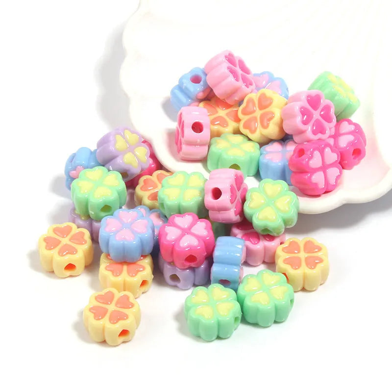 Assortment of 15mm frosted acrylic four-leaf clover beads in rose red, pink, yellow, green, blue, and purple colours.