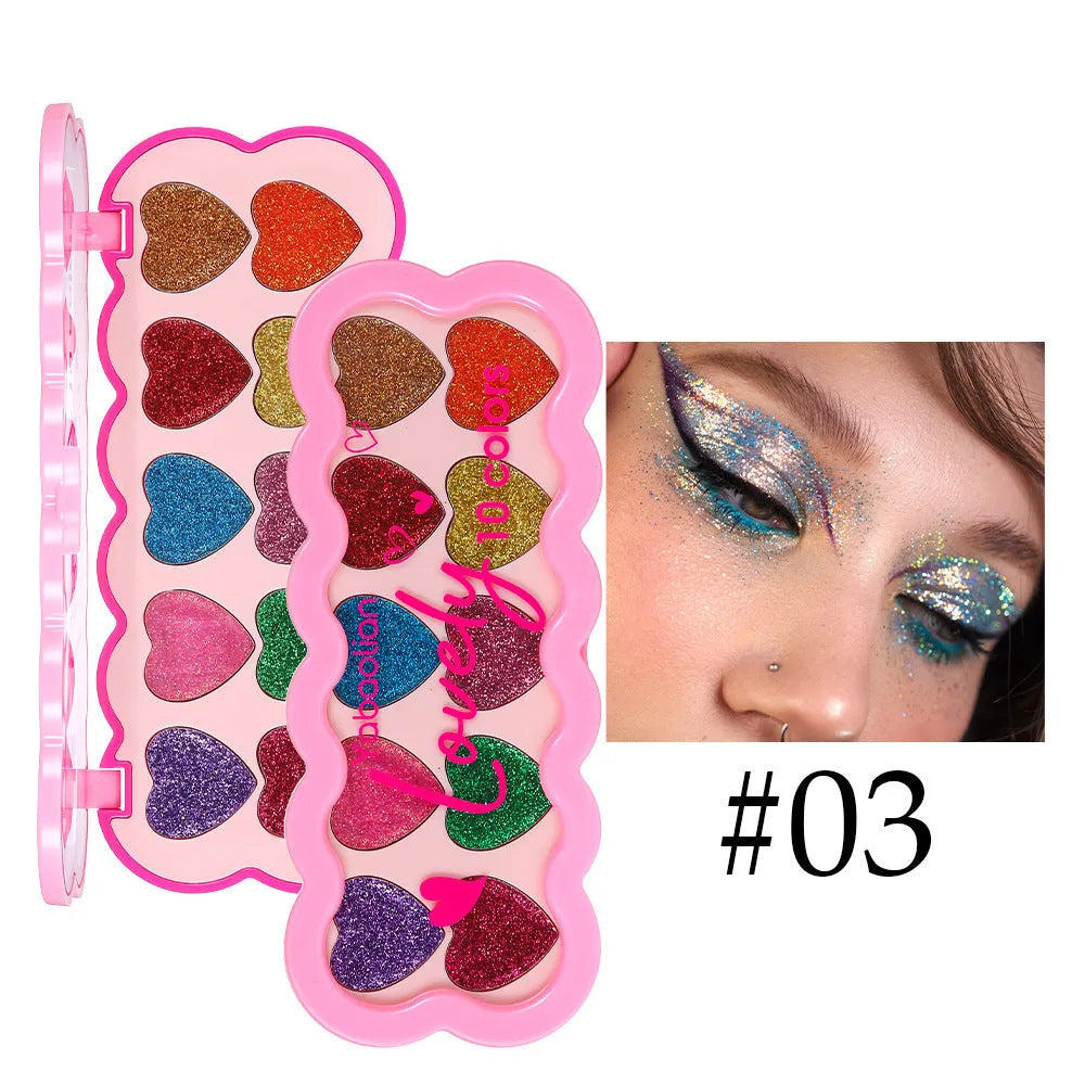 Heart-shaped ten-colour eye shadow palette with pearlescent sequin finishes in white, beige, pink, purple, brown, blue, black, royal blue, maroon, and coral.