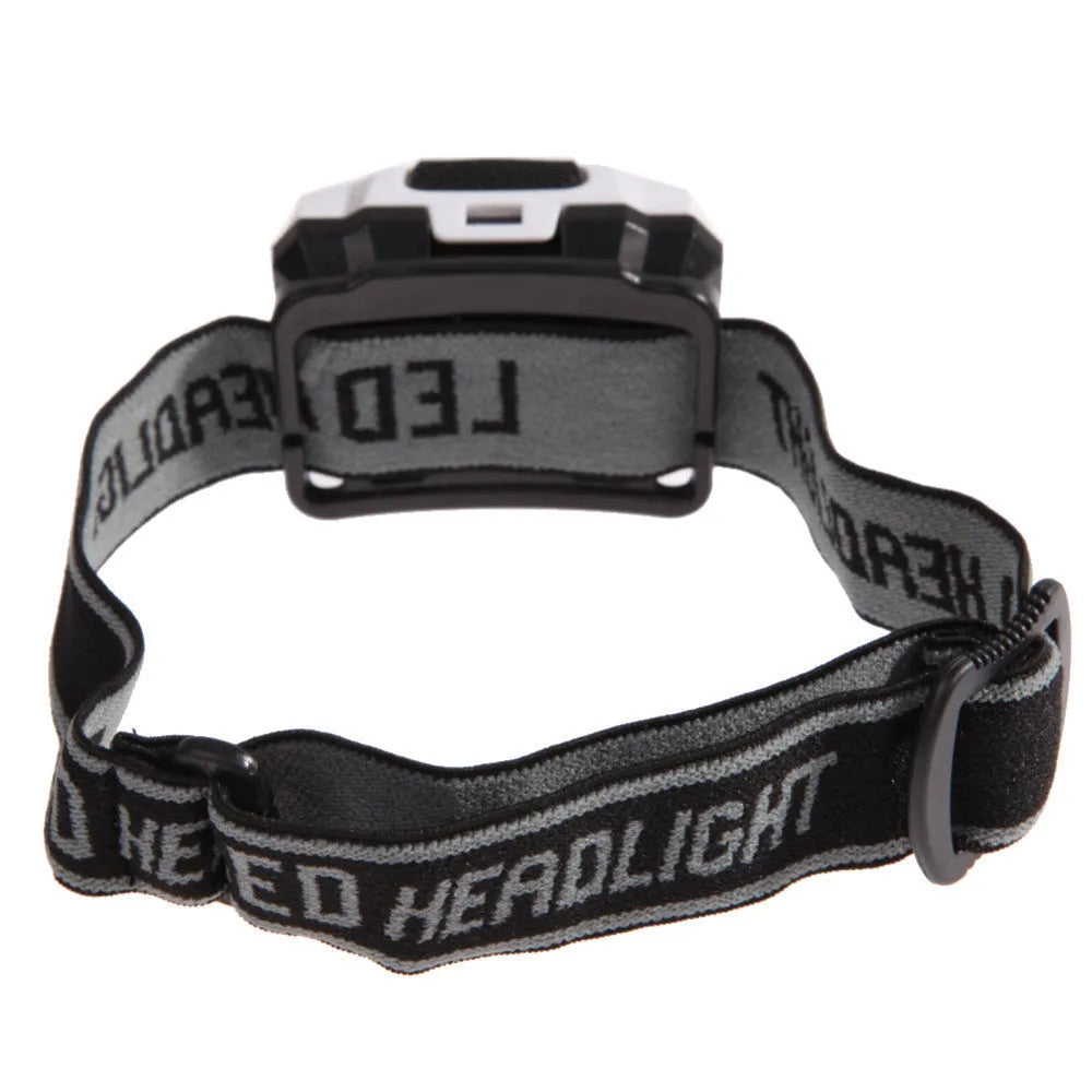 Black head torch with white and red LEDs mounted on an adjustable head strap for outdoor use.