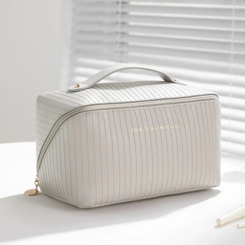 Beige cubic PU vertical pattern pillow makeup bag for travel, showing dimensions of 22.5cm by 12.5cm.