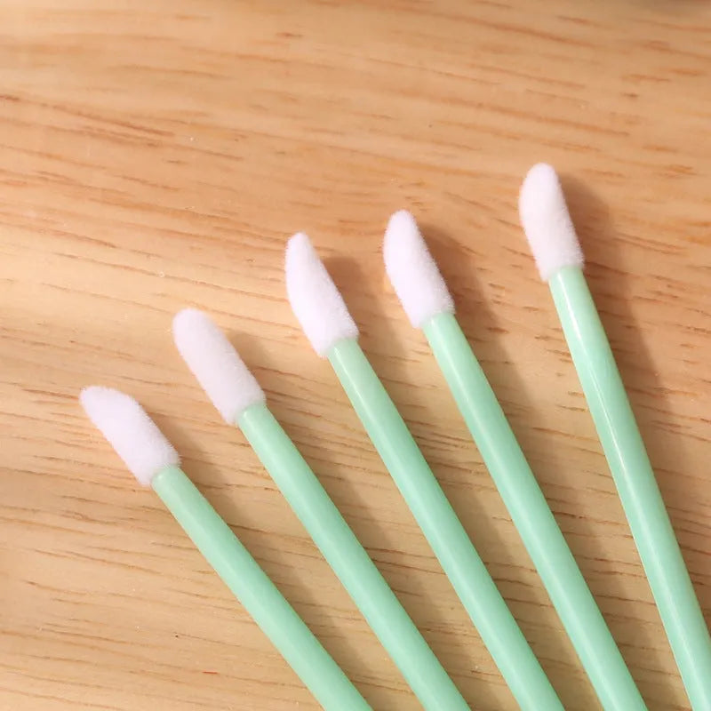 Disposable lip brushes with coloured handles and flocked brush heads for lip makeup application