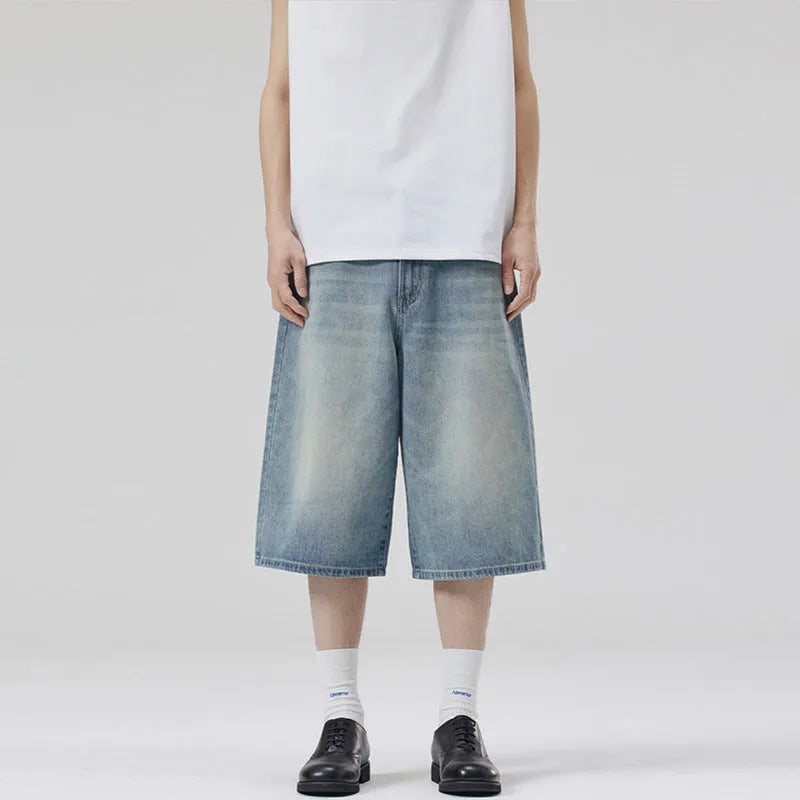 Men's loose fit straight-leg denim shorts in light blue on a plain background