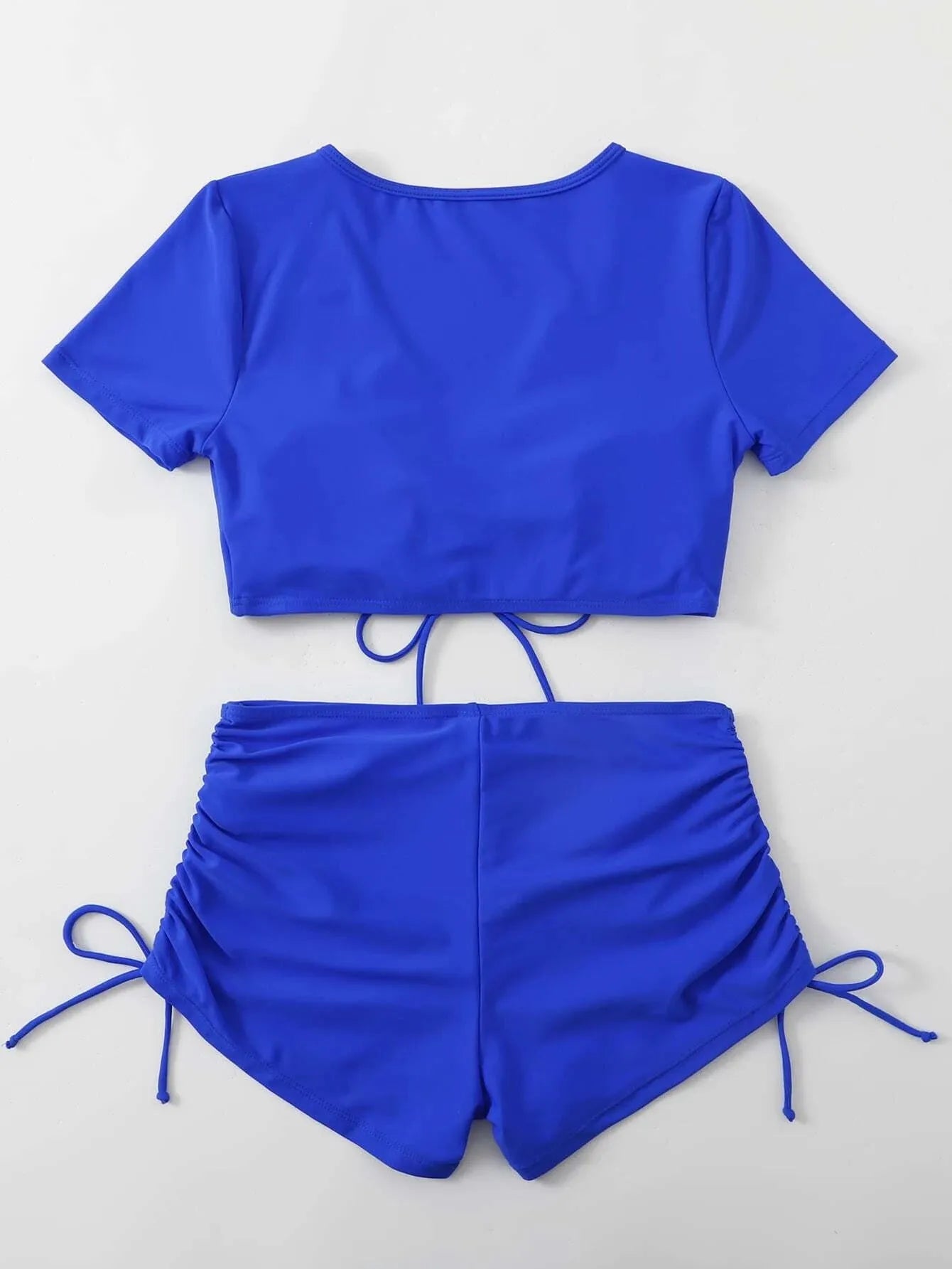 Women's dark green lace-up bow two-piece swimsuit with shorts on a mannequin