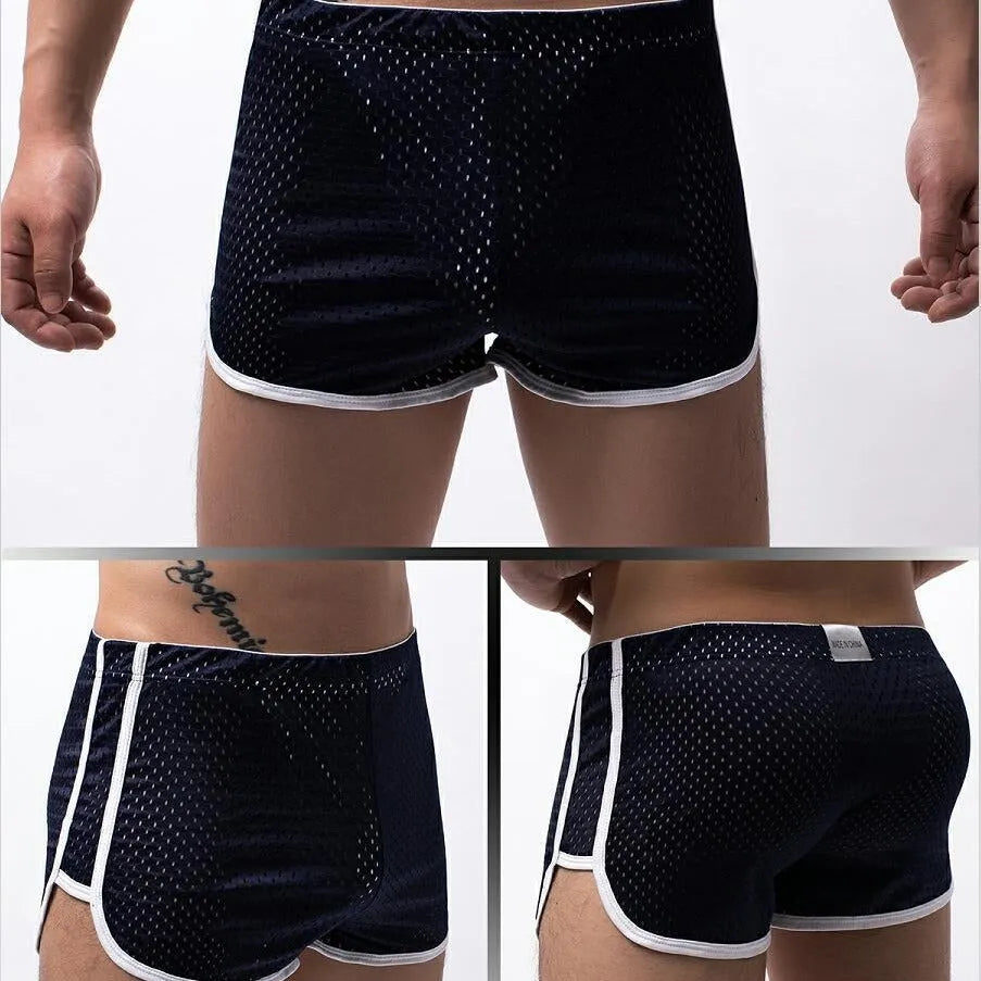 Men's solid colour boxer shorts in a cotton and nylon fabric blend, shown in black, on a mid-waist fit model.