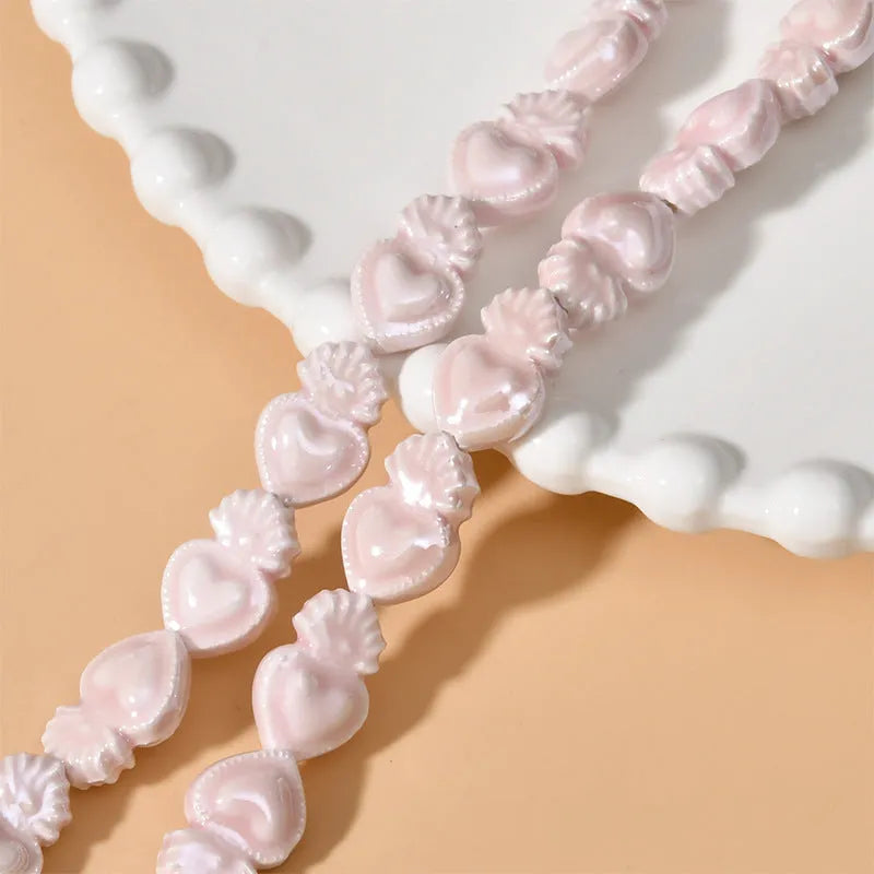 Ceramic heart torch beads in various colours for jewellery making, approximately 10mm by 15mm with straight hole