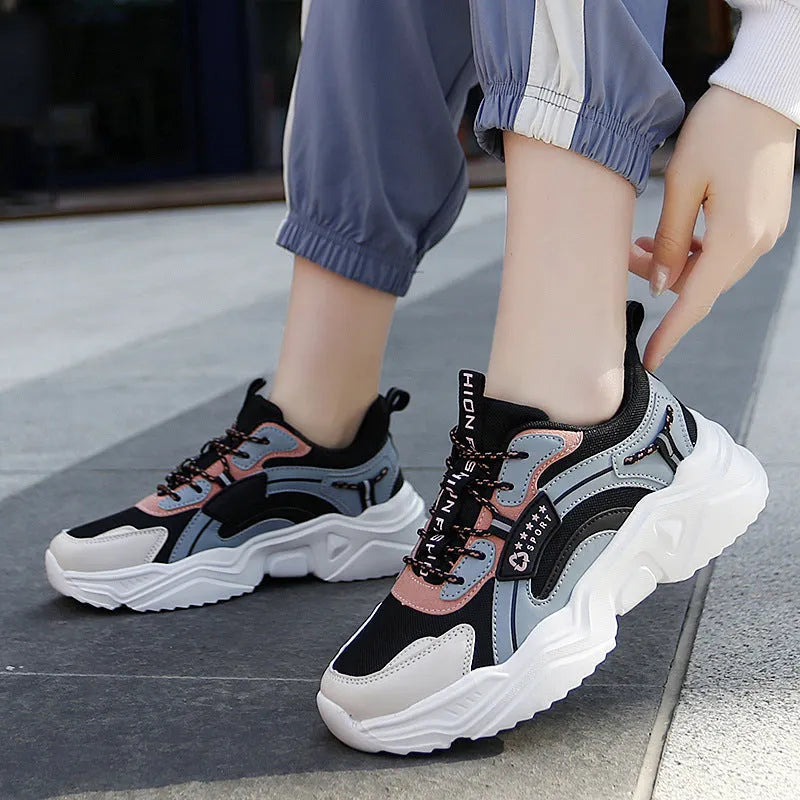 Women's white thick-soled casual sports shoes with mesh upper, round toe, and buckle closure.